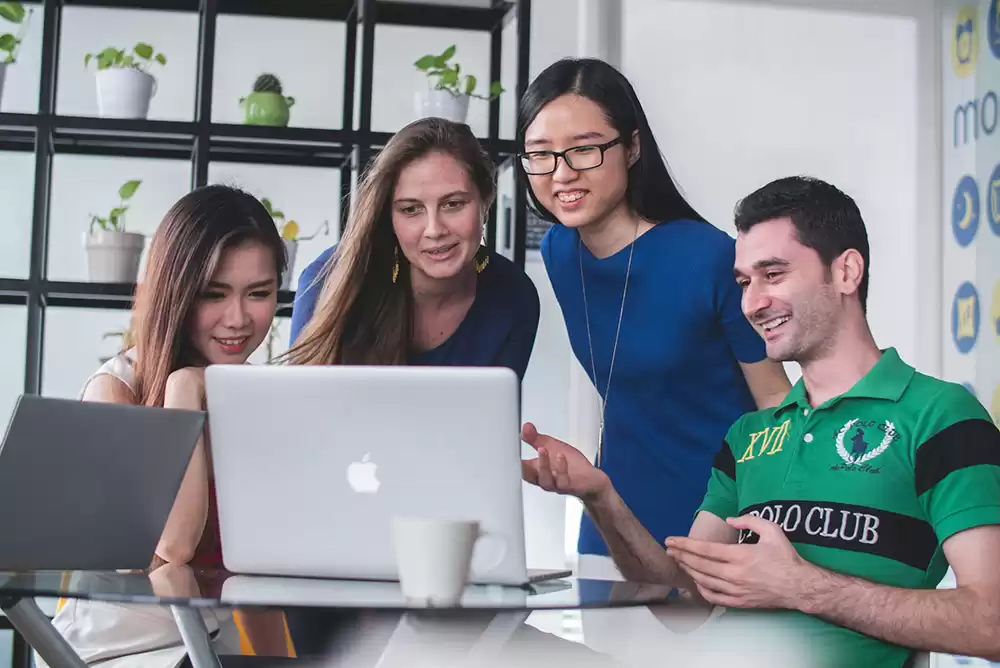 A business meeting around a laptop