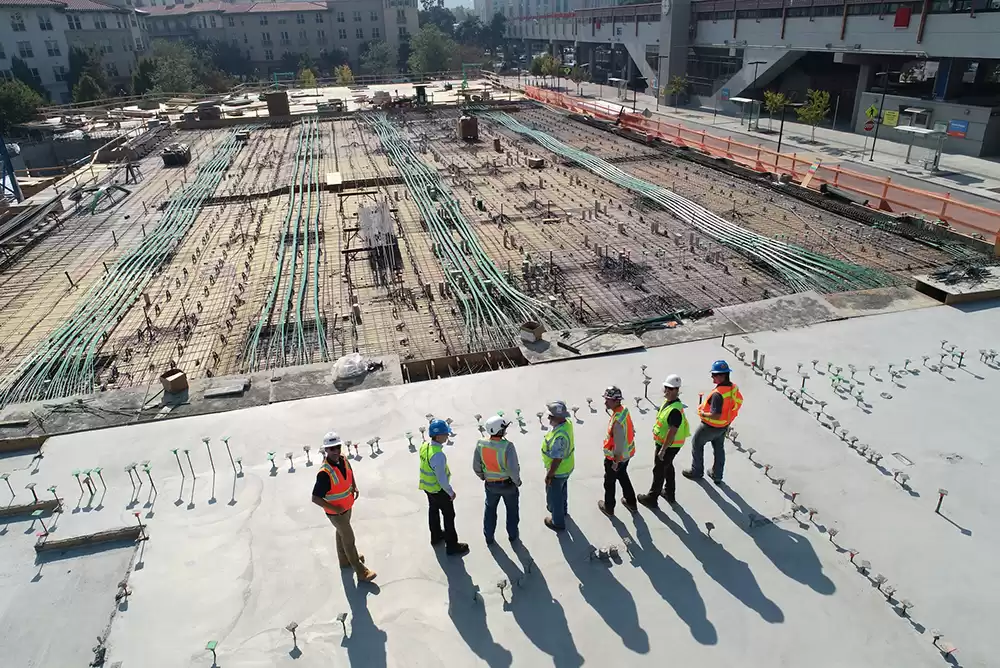 Construction workers examining a large project